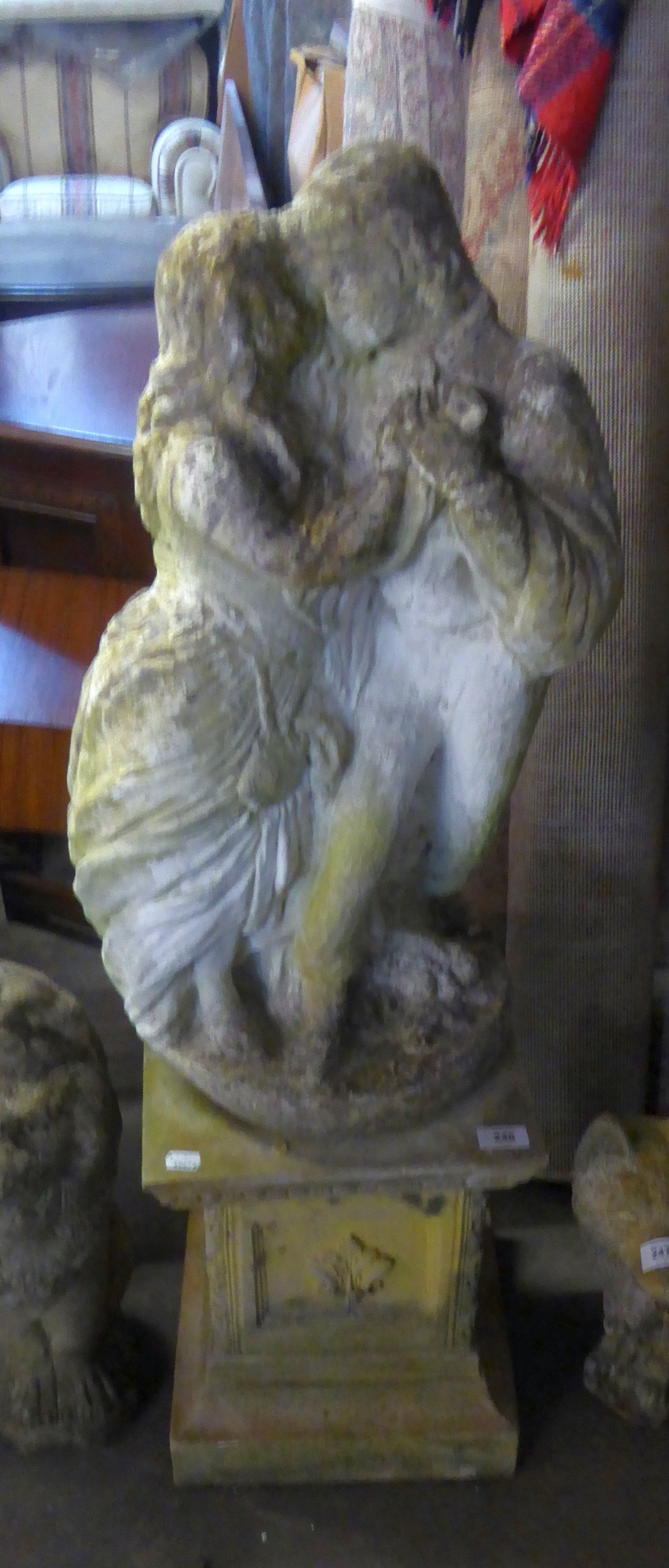 A GARDEN STATUE, A COUPLE HOLDING HANDS ON PLINTH BASE (CONCRETE) 42" HIGH ON PLINTH