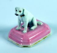CHAMBERLAIN’S WORCESTER PORCELAIN MODEL OF A SEATED DOG, on a canted oblong pink and gilt lined