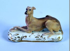 GRAINGER. LEE & Co, WORCESTER PORCELAIN MODEL OF A RECUMBENT GREYHOUND, painted in matt tones of