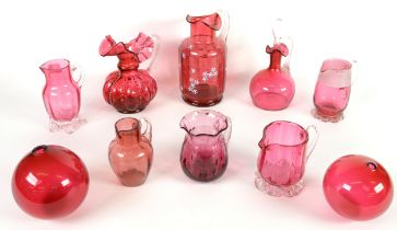 EIGHT CRANBERRY GLASS JUGS, including, one enamelled with tiny flowers, and another with stopper, 7”