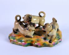ROYAL WORCEESTER PORCELAIN GROUP OF THREE PLAYFUL PUGS, circa 1862, painted in colours and set on