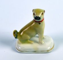 CHAMBERLAIN’S WORCESTER STYLE PORCELAIN MODEL OF A SEATED PUG, on a gilt lined rounded oblong