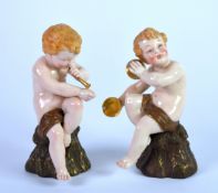 PAIR OF ROYAL WORCESTER PORCELAIN FIGURES OF CHERUB MUSICIANS, each modelled seated and playing an