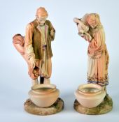 PAIR OF LATE VICTORIAN ROYAL WORCESTER PORCELAIN MODELS OF WATER CARRIERS, painted in muted tones