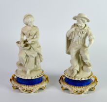 PAIR OF NINETEENTH CENTURY WHITE PARIAN SEATED FIGURES OF FISHERFOLK, he modelled carrying a net