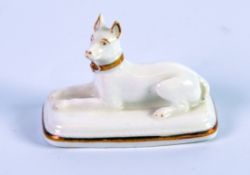 GRAINGER, LEE & Co, WORCESTER PORCELAIN MODEL OF A RECUMBENT HOUND, heightened in gilt, on a rounded