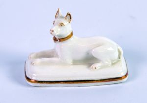 GRAINGER, LEE & Co, WORCESTER PORCELAIN MODEL OF A RECUMBENT HOUND, heightened in gilt, on a rounded