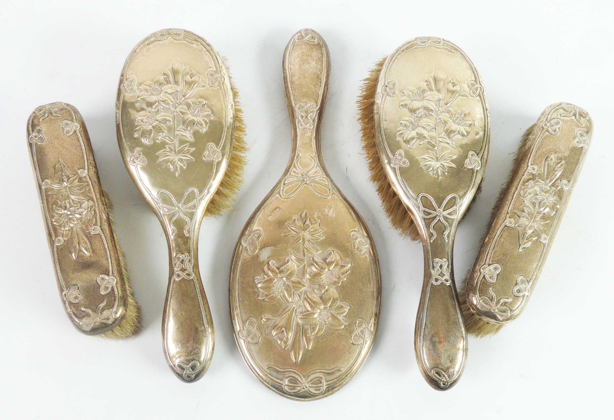 EDWARD VII FIVE PIECE SILVER CLAD DRESSING TABLE BRUSH SET, comprising: HAND MIRROR, with oval