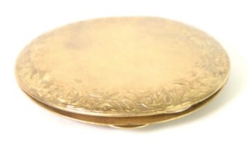 GOLD PLATED CIRCUAR POWDER COMPACT, engine turned with foliate scroll engraved broad border and