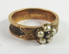 VICTORIAN GOLD COLOURED METAL MOURNING RING, set with a cluster of five seed pearls, the shank inset