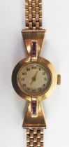 GOLD WRISTWATCH: Mid-twentieth century lady’s ruby set 9 ct gold wristwatch with integrated multi-