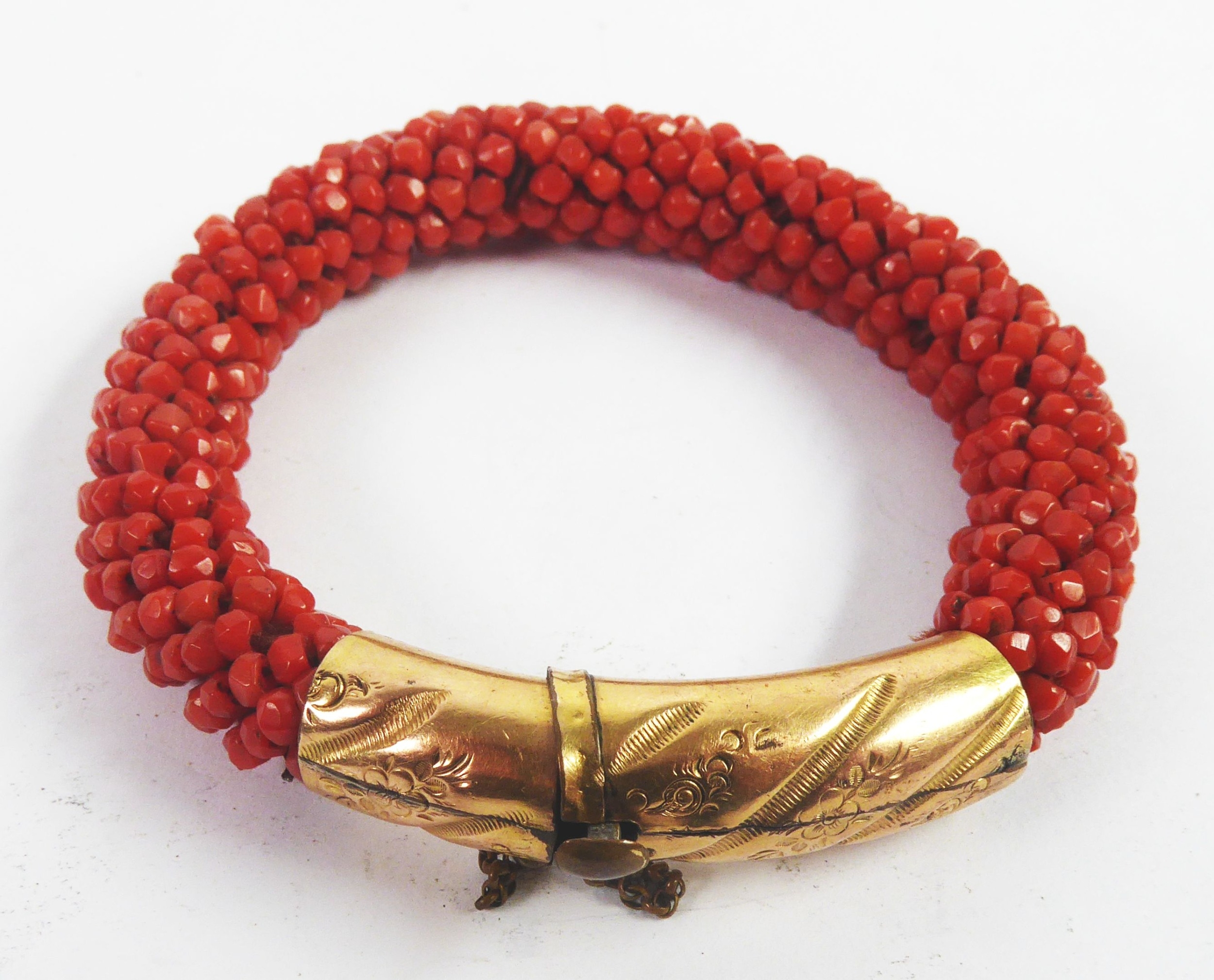 VICTORIAN BRACELET OF MULTIPLE RED CORAL BEADS, with gold plated cylindrican clasp engraved and
