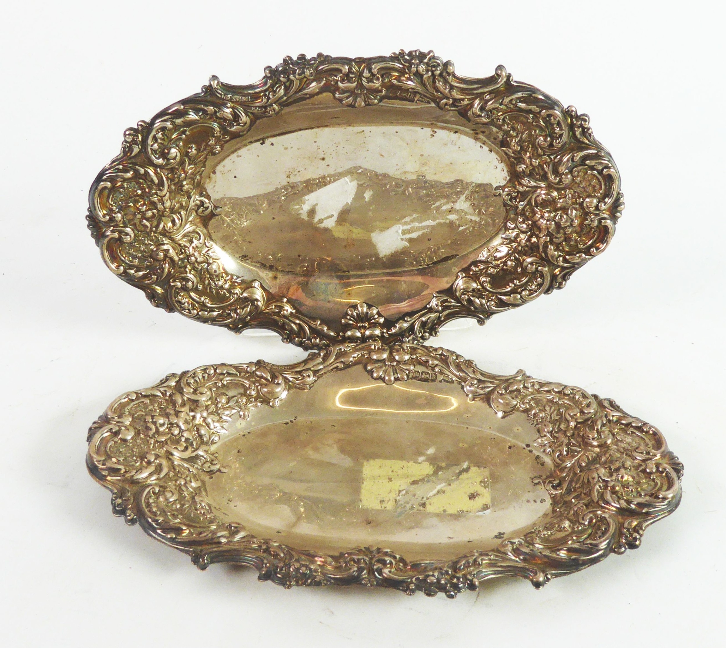 EDWARD VII PAIR OF EMBOSSED SILVER SMALL TRAYS OR STANDS BY WALKER & HALL, each of oval form with