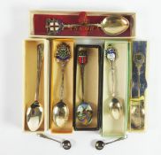 FOUR BOXED SILVER SOUVENIR TEASPOONS WITH ENAMELLED TOPS, ANOTHER IN ELECTROPLATE, a SILVER