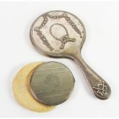 SILVER CLAD DRESSING TABLE HAND MIRROR, with circular bevelled plate and embossed floral pendant