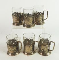 SET OF SIX RUSSIAN SILVER COLOURED METAL (84 MARK) CUP HOLDERS, each with angular scroll handle,