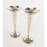 GEORGE V PAIR OF WEIGHTED SILVER TRUMPET VASES, with shaped rims, pierced borders and circular