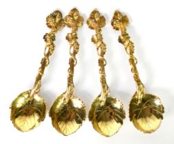 SET OF FOUR, PROBABLY 18th CENTURY, SILVER GILT DESSERT SERVING SPOONS, with vine leaf shaped bowls,