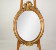 ROCOCO WALL MIRROR: A good Victorian gilt-framed oval cameo wall mirror with C-scroll cartouche