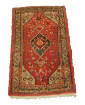 HAMADAN, PERSIAN RUG, with hexagonal centre medallion with pendants, on a crimson field with green