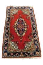 PERSIAN RUG WITH LARGE, OVAL CENTRE MEDALLION, with small pendants, plain crimson field, fancy