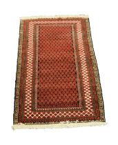 BELUCH, PERSIAN RUG with all-over compact crimson pattern on a black field, multiple border stripes,