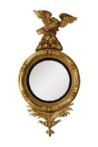 REGENCY CAPTAIN’S MIRROR: Large giltwood convex wall mirror with ebonized bezel and framed in a
