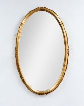 MODERN OVAL MIRROR: Small giltwood modern wall mirror, with bevelled glass and serpentine frame. 28”