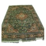 KIRMAN, PERSIAN, SMALL SILKY PILE CARPET, with scolloped circular centre medallion, with pendants on