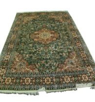 KIRMAN, PERSIAN, SMALL SILKY PILE CARPET, with scolloped circular centre medallion, with pendants on