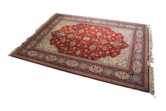 MACHINE WOVEN WOOL CARPET OF PERSIAN DESIGN, with all-over Herati design on a wine red field, with