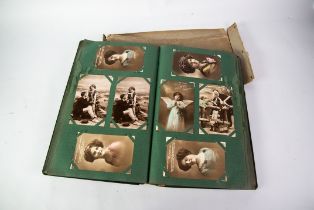 AN EARLY 20TH CENTURY ALBUM CONTAINING APPROXIMATELY 380 POSTCARDS, including photographic