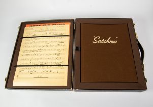 LOUIS ARMSTRONG 'SATCHMO' FACSIMILE TRAVEL CASE WITH BIOGRAPHICAL CONTENTS