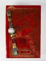 SWATCH ‘MAGIC SPELL’ LIMITED EDITION WRISTWATCH, GZ148, (1995), in red and gilt book pattern case