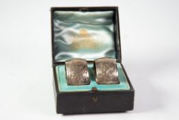 PAIR OF VICTORIAN ENGRAVED NAPKIN RINGS, circular and cushion sided, with foliate scroll