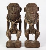 PAIR OF ETHNOGRAPHIC CARVED WOODEN squatting male and female figures, each 11 ¾" (37cm) high (2)