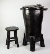 MODERN EBONISED WOODEN DRUM SHAPED SEAT, crudely carved with hinged lid, lug handles and peg feet,