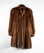BROWN FULL LENGTH MINK COAT with shawl collar, top button at the collar and two hook fasteners to