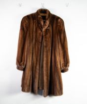 BROWN FULL LENGTH MINK COAT with shawl collar, top button at the collar and two hook fasteners to