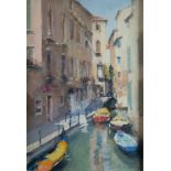 BOB RICHARDSON (1938) PASTEL Venetian canal scene with moored boats and a gondola in the