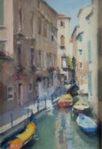 BOB RICHARDSON (1938) PASTEL Venetian canal scene with moored boats and a gondola in the