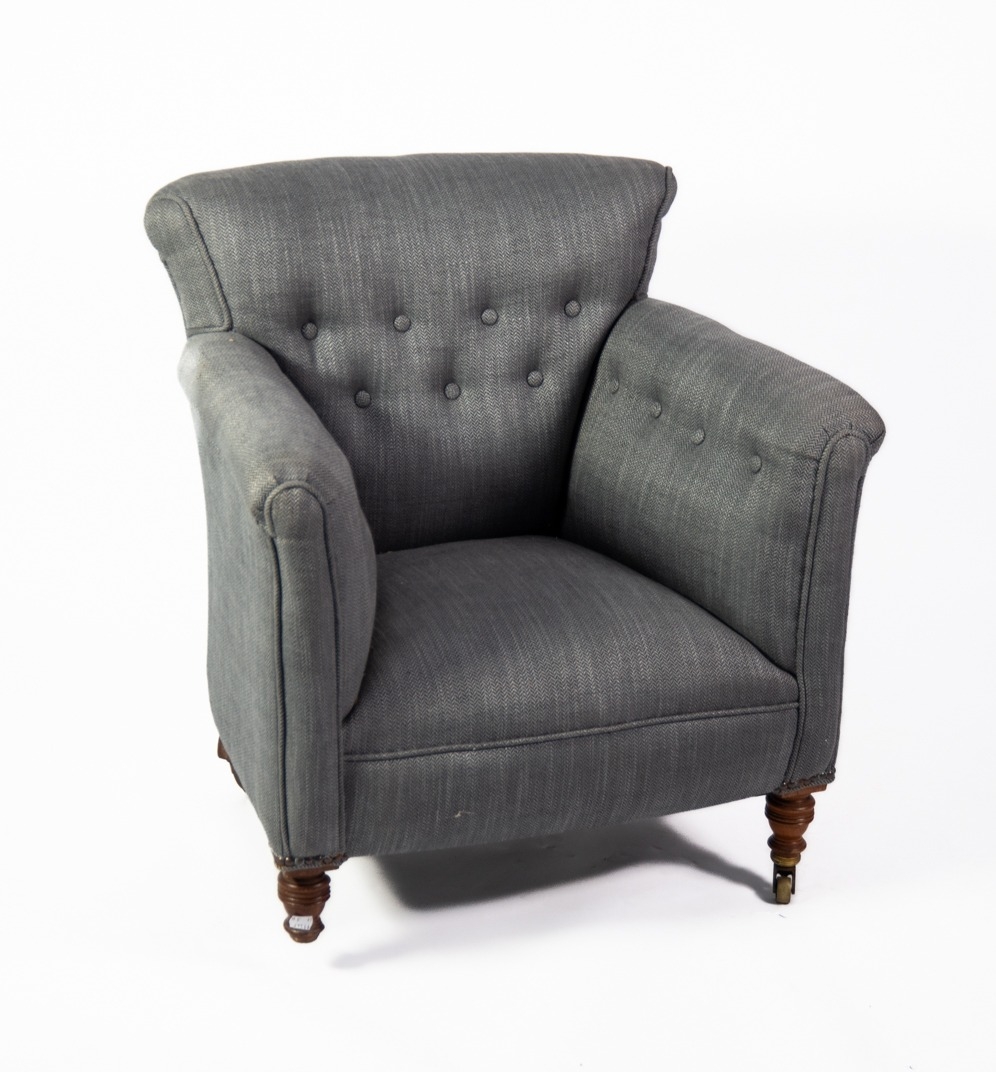 HOWARD & SONS LATE 19th/EARLY 20th SMALL LOUNGE CHAIR with low, slightly fan shaped back, button