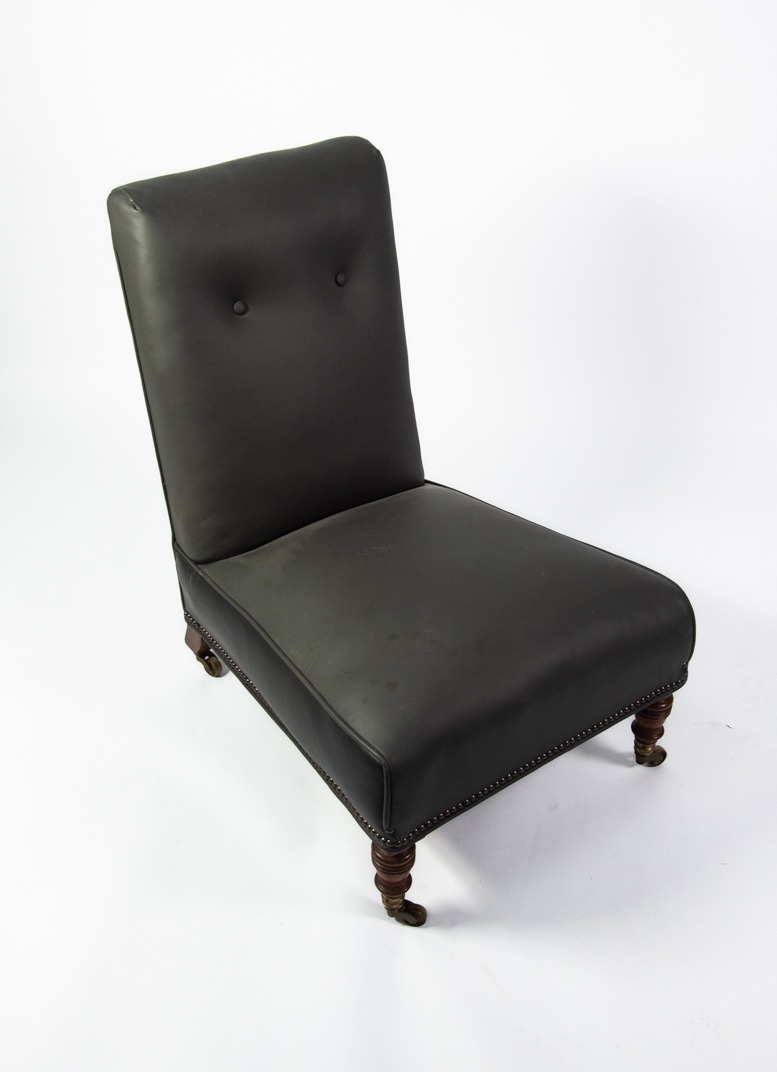 HOWARD & SONS VICTORIAN 'SLIPPER' LOW-SEATED ARMLESS EASY CHAIR, the rectangular high back and