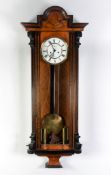 EARLY TWENTIETH CENTURY VIENNA WALL CLOCK IN FIGURED WALNUT AND EBONISED CASE, the 7” two part Roman