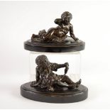 PAIR OF NINETEENTH CENTURY PATINATED BRONZE FIGURES OF RECUMBENT CHERUBS, each cast semi draped,