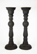 PAIR OF MODERN BLACK RECONSTITIUTED STONE FLOOR STANDING CANDLE HOLDERS, each of traditional