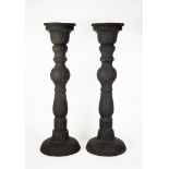 PAIR OF MODERN BLACK RECONSTITIUTED STONE FLOOR STANDING CANDLE HOLDERS, each of traditional