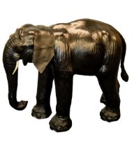 LIBERTY’S STYLE MODERN BLACK LEATHER COVERED MODEL OF AN ELEPHANT, with trunk down, flapping ears