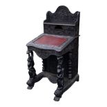 NINETEENTH CENTURY ANGLO INDIAN HEAVILY CARVED AND DARK STAINED HARDWOOD DAVENPORT DESK, the