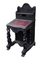 NINETEENTH CENTURY ANGLO INDIAN HEAVILY CARVED AND DARK STAINED HARDWOOD DAVENPORT DESK, the